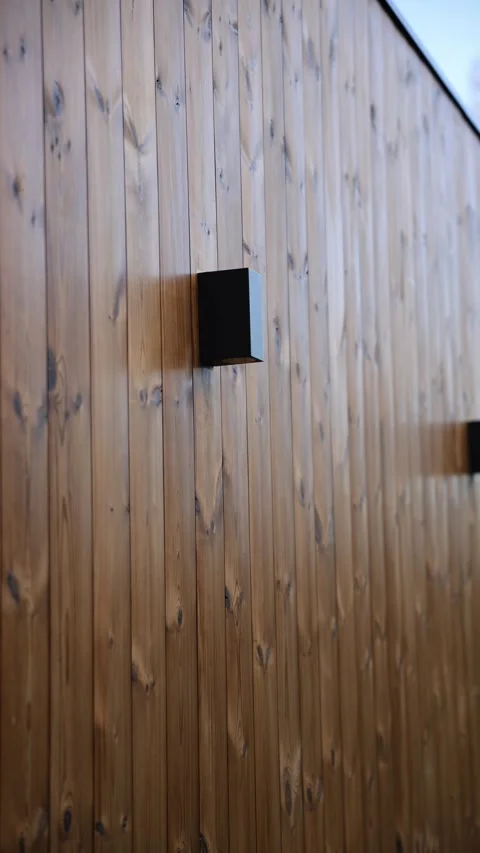 Modern facade with vertical wooden cladding and black cube lights Stock Footage 324795506