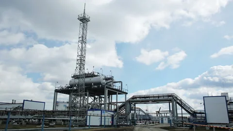 Modern facility with pipes or powerful process area at the oil depot or tank far Stock Footage 199487799