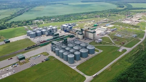 Modern factory among fields. Grain elevators for keeping agricultural products. Stock Footage 134775640