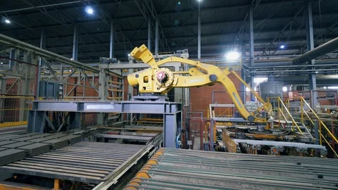 Modern factory machine moves bricks from a conveyor in a facility. Stock Footage 119170433