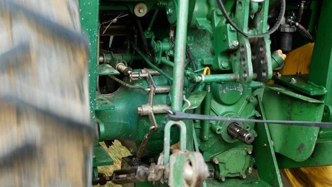 Modern Farm Tractor Close-Up from behind as it is driving in a field. Stock Footage 115049402