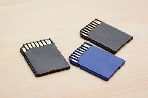 Modern fast SD memory cards on wooden table Stock Photos
