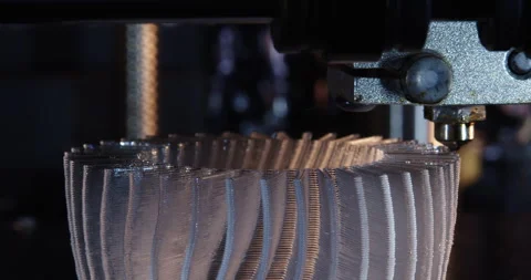 A modern FDM 3D printer nozzle extrudes plastic filament layer by layer. Close Stock Footage 326371027