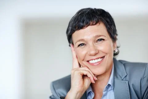 Modern female executive. Closeup portrait of modern business woman smiling at Stock Photos