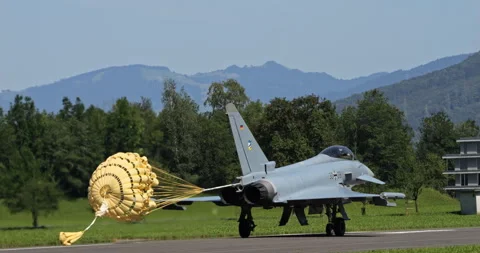 Modern Fighter Jet Rolls Down Runway with Parachute Still Attached Stockbeeldmateriaal 251540156