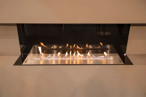 Modern fireplace built into the wall, a rooftop fireplace luxury style. Stock Photos