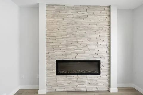 Modern fireplace with stone accent wall Stock Photos