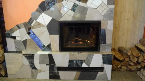 Modern fireplace with unique tile design in cozy living room setting during wint Stock Footage 331368910