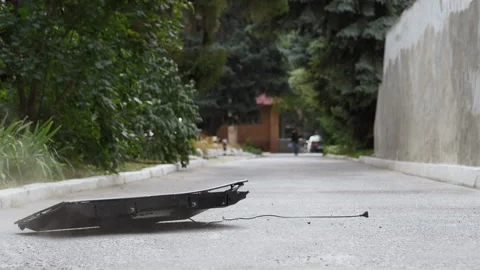 Modern flat screen TV falls on the asphalt from a height and crashes in slow Stock Footage 161474269