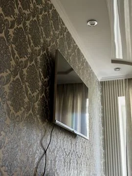 Modern Flat Screen TV Mounted on Wall in Interior Stock Photos
