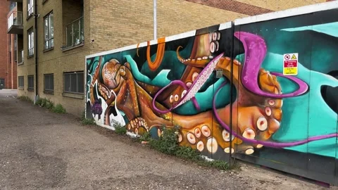 Modern flats and Octopus Graffiti on Urban Fence in UK City Video stock 332173189