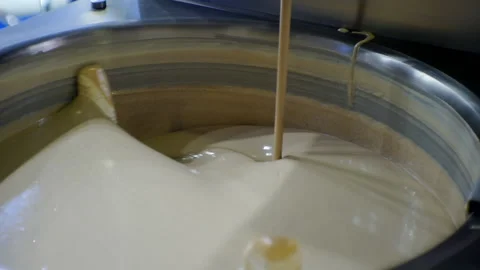 Modern food production.technological process.melted liquid chocolate is mixed in Stock Footage 151925853