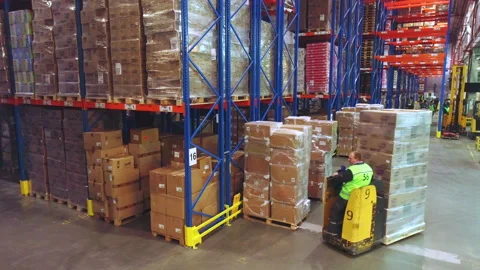 Modern forklift in a warehouse with boxes. The work of modern equipment in the Stock Footage 173452760