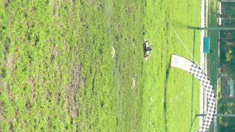 Modern FPV drones flying over grass field Stock Footage 91143680