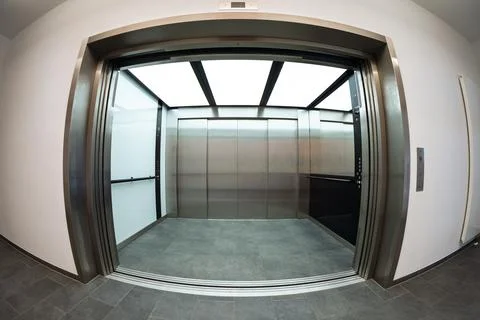 Modern freight elevator with open doors in fisheye perspective Stock Photos
