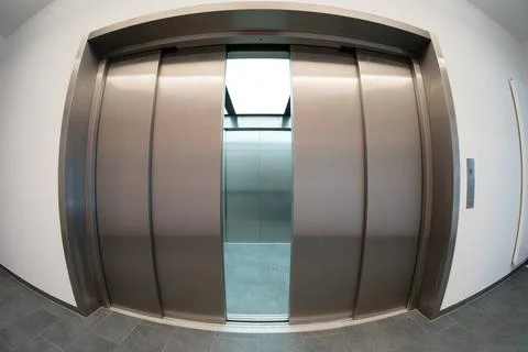 Modern freight elevator with partially open doors in fisheye view Stock Photos
