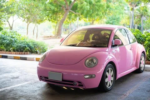 Modern fun pink small car. Photo of a modern funky pink car parked Stock Photos