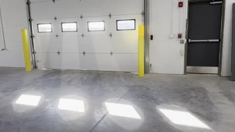 Modern garage interior with sunlight streaming through windows Stock Footage 295789461