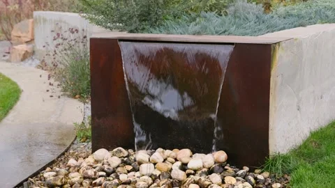Modern garden waterfall with stone base and concrete walls Stock Footage 306775727