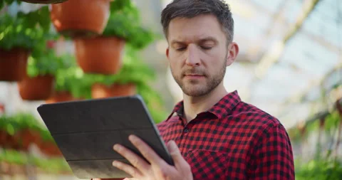Modern Gardener Using Digital Tablet in Greenhouse Stock Footage 308132782