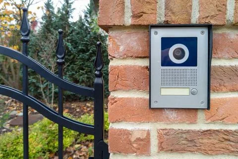 Modern gate intercom with camera on brick wall Foto stock