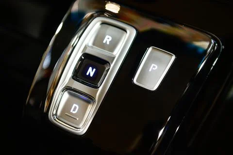 Modern gearbox control button on a central console in a new car Stock Photos