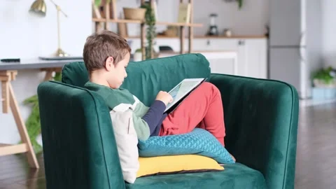 Modern generation. Kid playing on ipad. Little boy is smiling while playing with Stock Footage 160974680