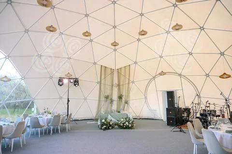 Modern geodesic dome interior with elegant decor and dining setup Stock Photos