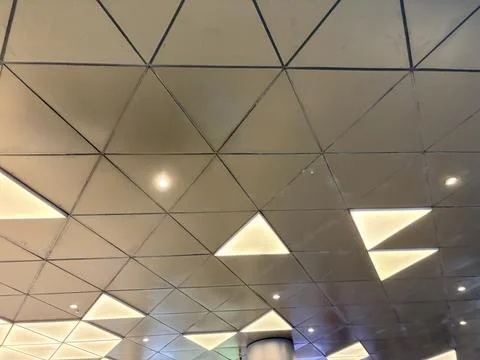 Modern geometric ceiling with ambient lighting. Stock-Fotos