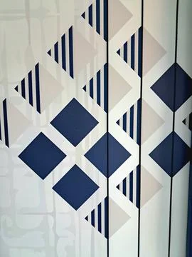 Modern geometric pattern background with blue navy and cream diamond shapes. Stock Photos