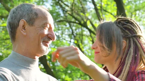 Modern girl with dreadlocks is hugging her senior father spending time together Stock Footage 131541092