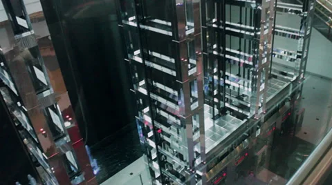 Modern glass and metal elevators rise and fall in an airport. Stock Footage 39790120
