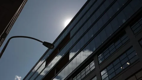 Modern glass building facade with sun flare Stock Footage 337564224