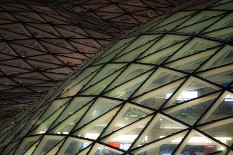 Modern glass building facade with triangular panels Stock Photos