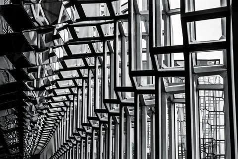 Modern glass building interior featuring geometric panels and reflective su.. Fotos Stock
