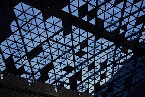 Modern glass ceiling with triangular pattern against blue sky. Fotos de archivo