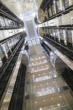 Modern glass elevator atrium in luxury cruise ship interior Stock Photos