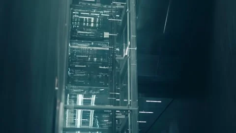 A modern glass elevator shaft ensures the operation of a multi-story building Stock Footage 323851070