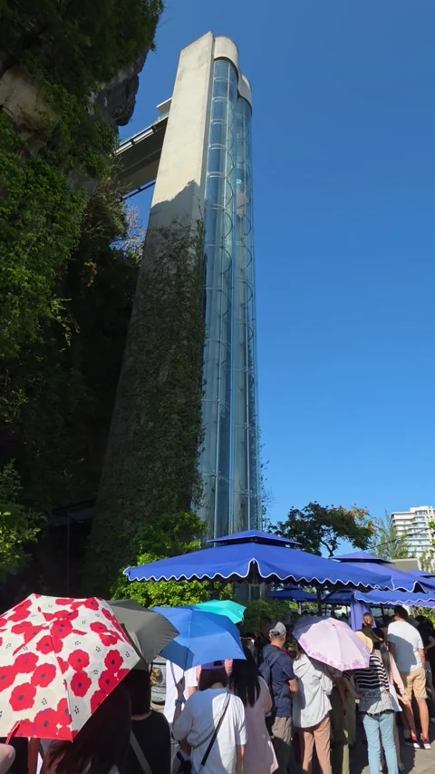 Modern glass elevator taking tourists up Thuy Son mountain at Marble Mountains Stock Footage 333112438