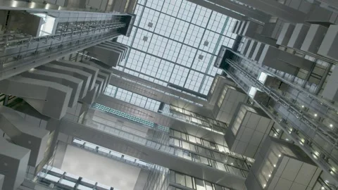 Modern Glass Elevators and Geometric Atrium Architecture in Bright Urban Stock Footage 334540781