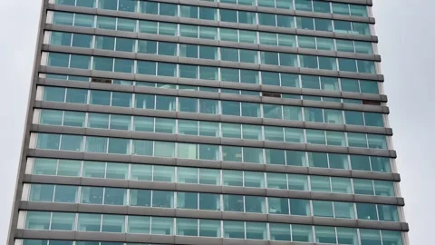 A Modern Glass Facade Building featuring Multiple Levels and unique design Stock Footage 304834992