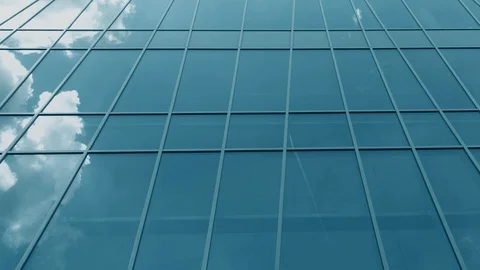 Modern glass facade windows reflect flying airplane and clouds, time lapse shot Stock Footage 109068323