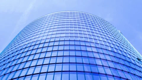 Modern glass skyscraper with blue sky reflecting on windows motion footage Stock-Footage 342906450