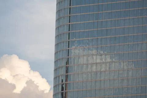 Modern glass skyscraper with dramatic clouds in Houston Stock Photos