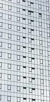 **Modern glass skyscraper facade with repeating grid of windows, abstract Stock Photos