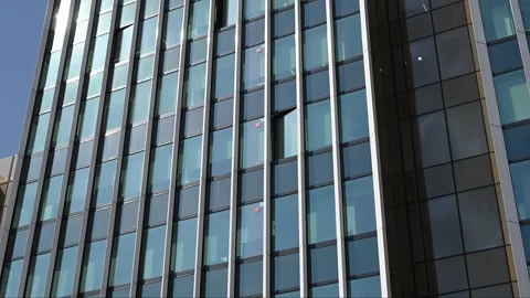 Modern glass skyscraper facade with vertical metal frames Stock Footage 331582255