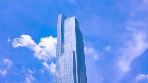 Modern glass skyscraper reaching into clear blue sky Stock Footage 342273601