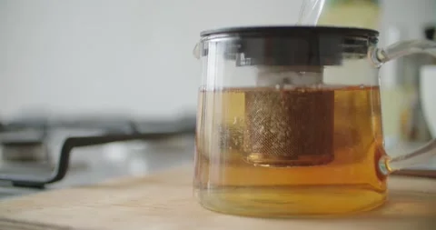 Modern glass teapot with designed infuser for perfect tea brewing Stock Footage 299716065