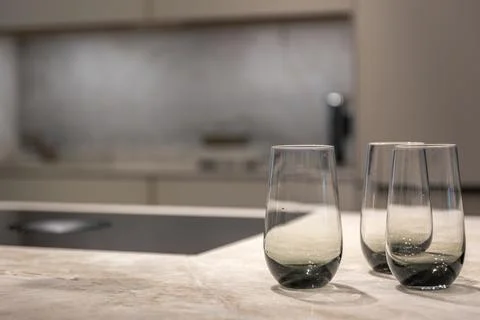 Modern glasses on a stone kitchen surface. Stylish details of a premium kit.. Fotos Stock