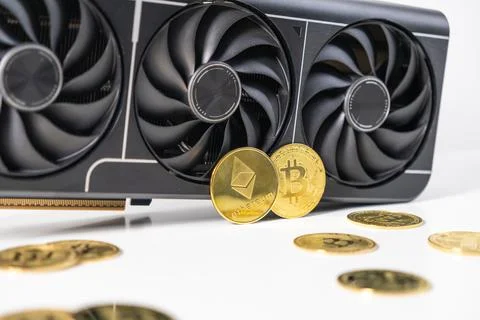 Modern GPU with triple-fan design surrounded by golden Bitcoin and Ethereum.. Stock Photos
